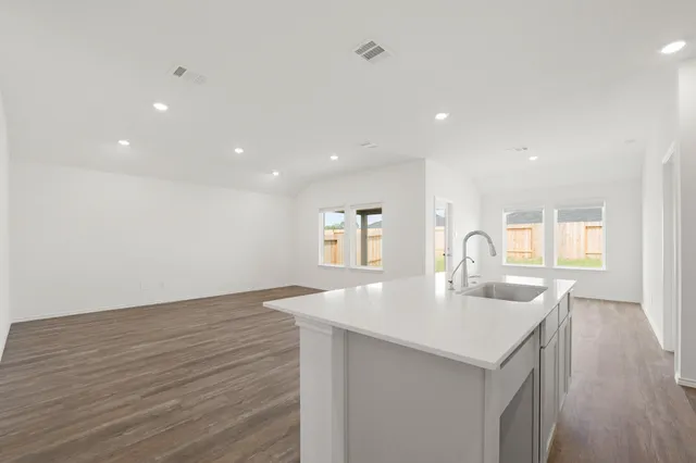 a kitchen with sink and mirror