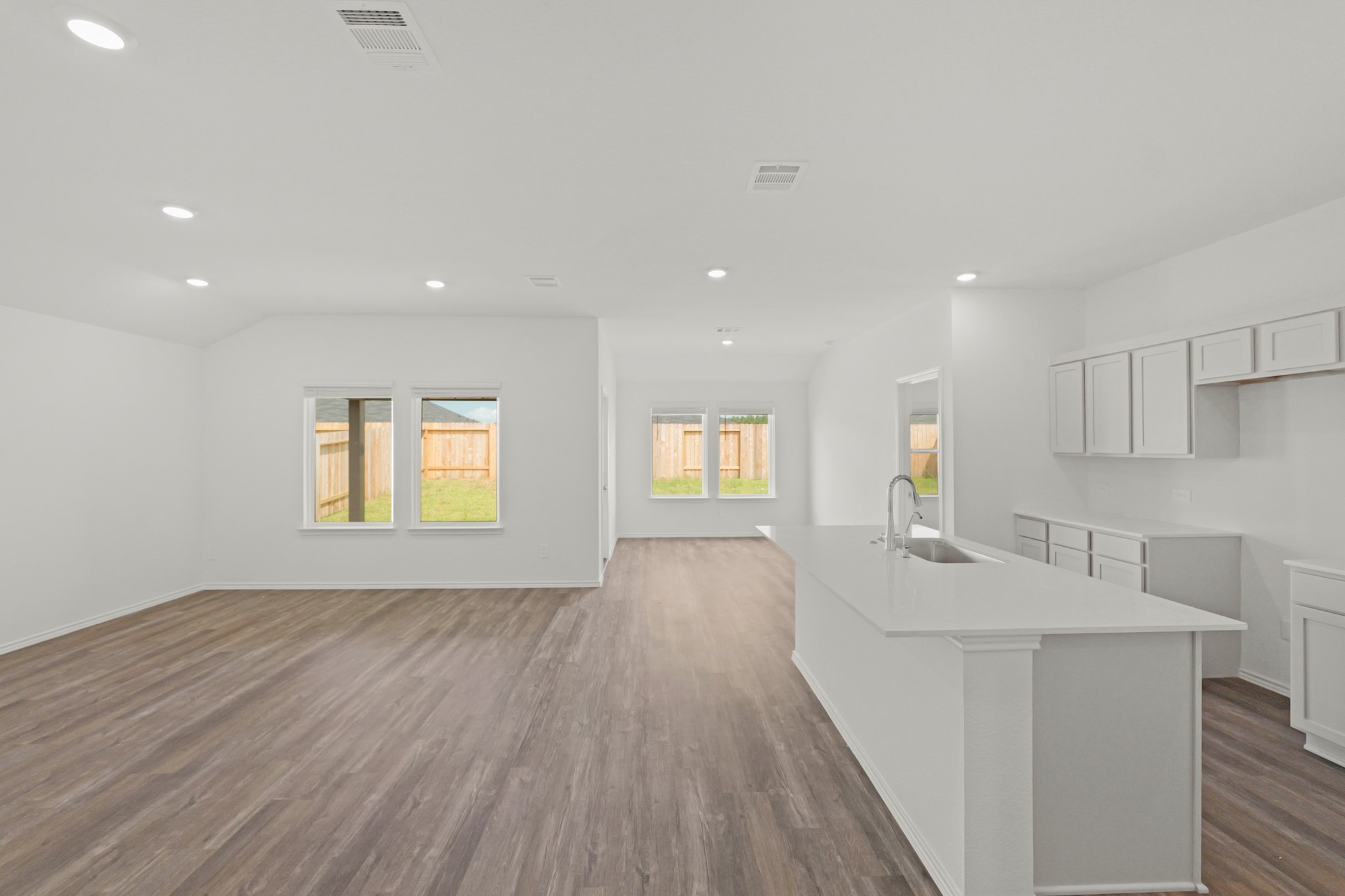 14392 Oceanblue Way Splendora, TX 77372 - Photo 9 of 30 a view of an empty room with wooden floor and a window