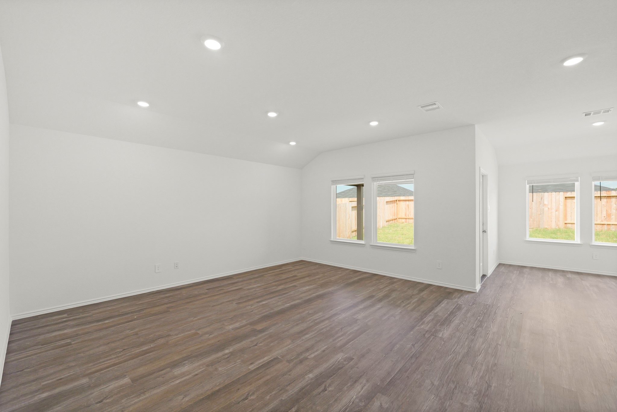 14392 Oceanblue Way Splendora, TX 77372 - Photo 10 of 30 an empty room with wooden floor and windows
