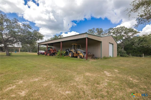 a view of a house with backyard and porch