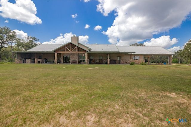 a front view of a building with a yard
