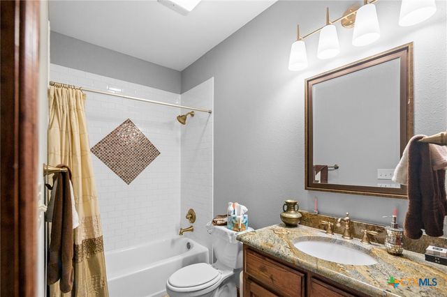 a view of a yard in front of a house with large trees