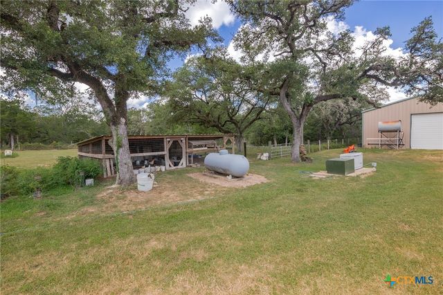 a backyard of a house with table and chairs