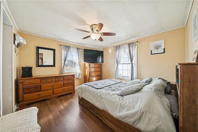 a bedroom with a bed and wooden floor