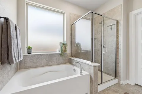 a bathroom with a bathtub and a shower