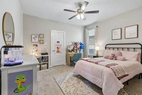 a bedroom with a bed a desk and chair