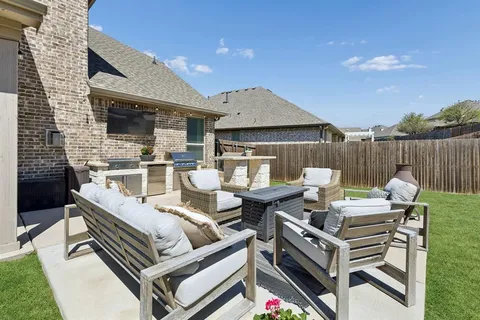 a view of a patio with a table and chairs