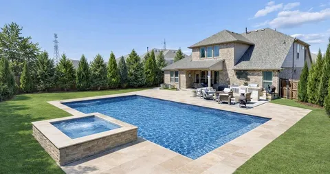 a view of a house with swimming pool and sitting area