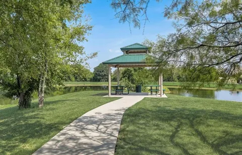 a view of a park with large trees