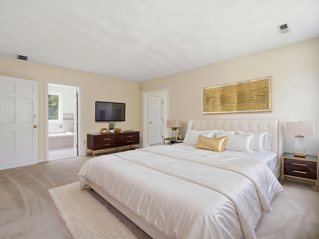 10 Hawk Ridge Road Andover, MA 01810 - Photo 20 of 32 a bedroom with a bed and a flat screen tv