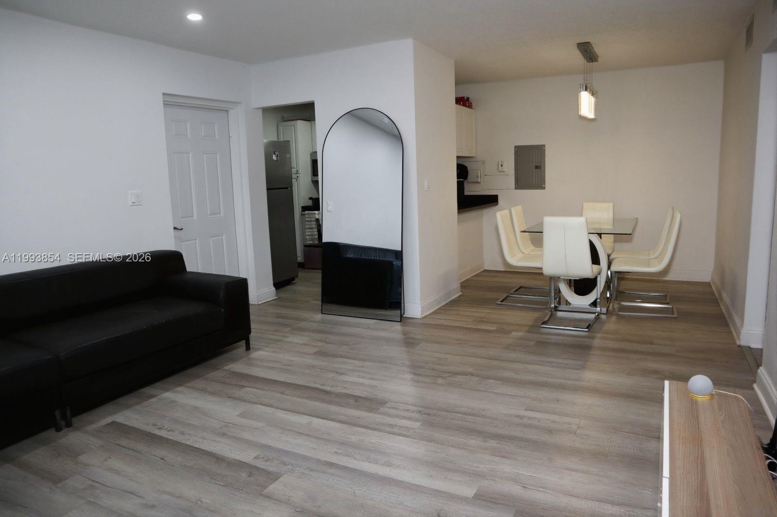 13785 Southwest 66th Street, Unit 239C Miami, FL 33183 - Photo 11 of 17 a living room with furniture and a wooden floor