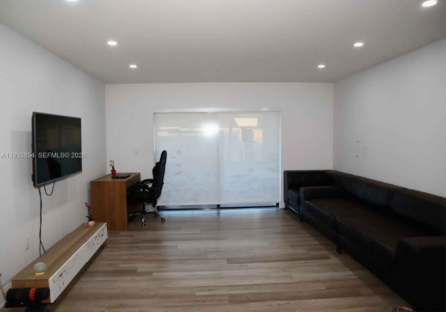 13785 Southwest 66th Street, Unit 239C Miami, FL 33183 - Photo 9 of 17 a living room with furniture and a flat screen tv