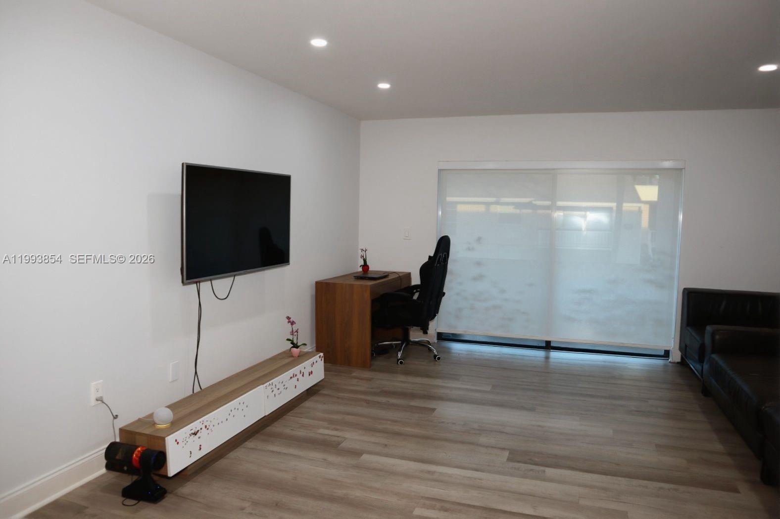 13785 Southwest 66th Street, Unit 239C Miami, FL 33183 - Photo 10 of 17 a room with gym equipment and a flat screen tv