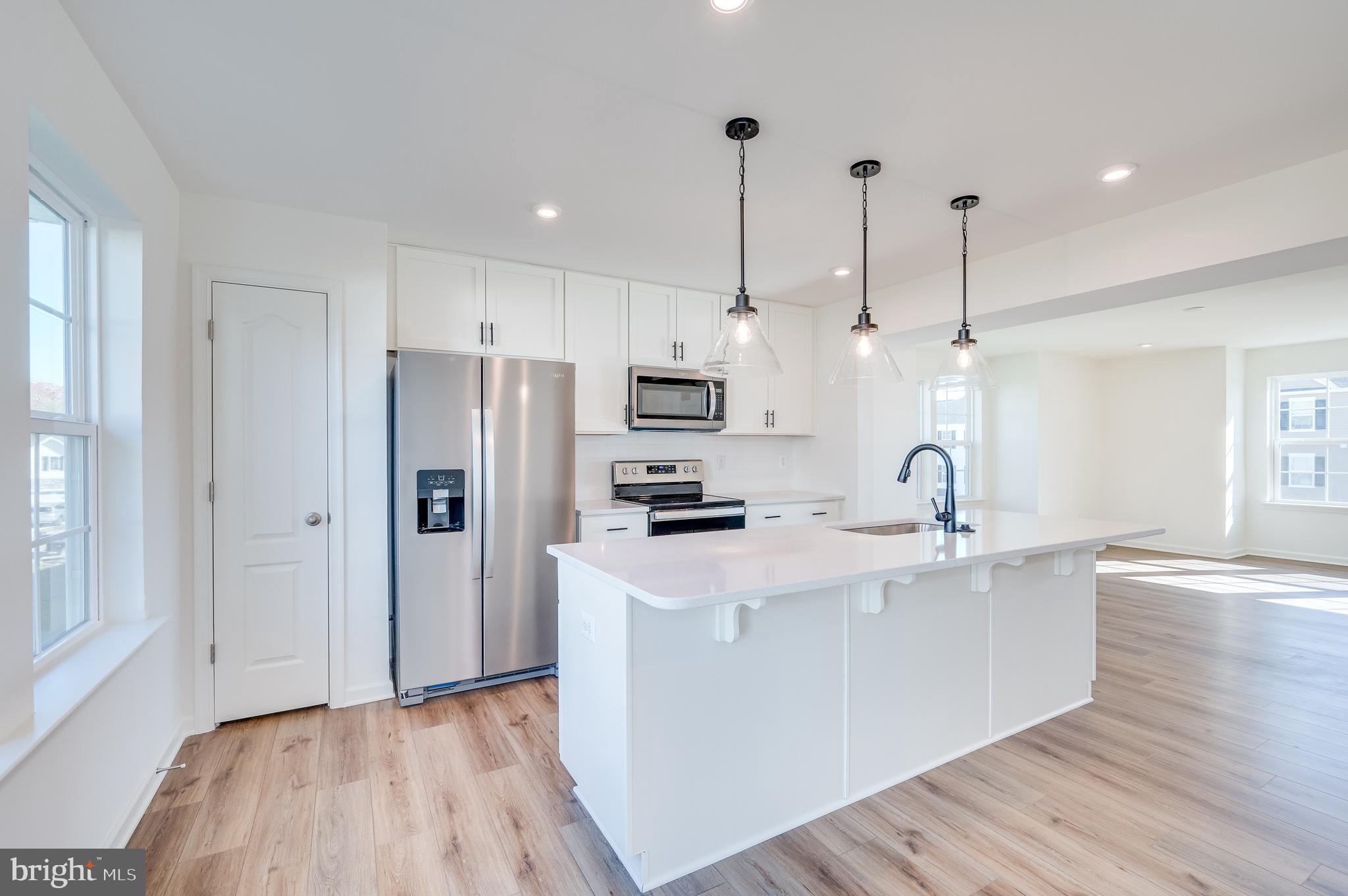 115 Tuxford Road Falling Waters, WV 25419 - Photo 20 of 44 a kitchen with stainless steel appliances granite countertop a sink a stove a refrigerator and island with wooden floor
