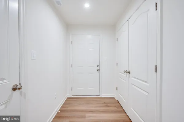 a view of a hallway with wooden floor