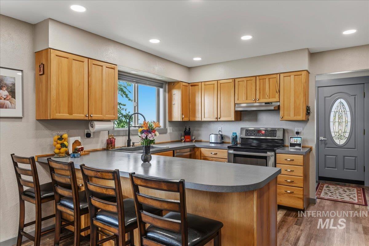 6323 Foothill Road Star, ID 83669 - Photo 11 of 50 Kitchen featuring wood-finish cabinetry, stainless steel appliances, a large window, and recessed lighting