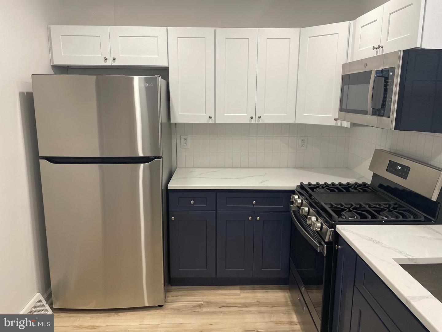 105 Breslin Avenue Haddonfield, NJ 08033 - Photo 3 of 15 a kitchen with refrigerator a stove a microwave and cabinets