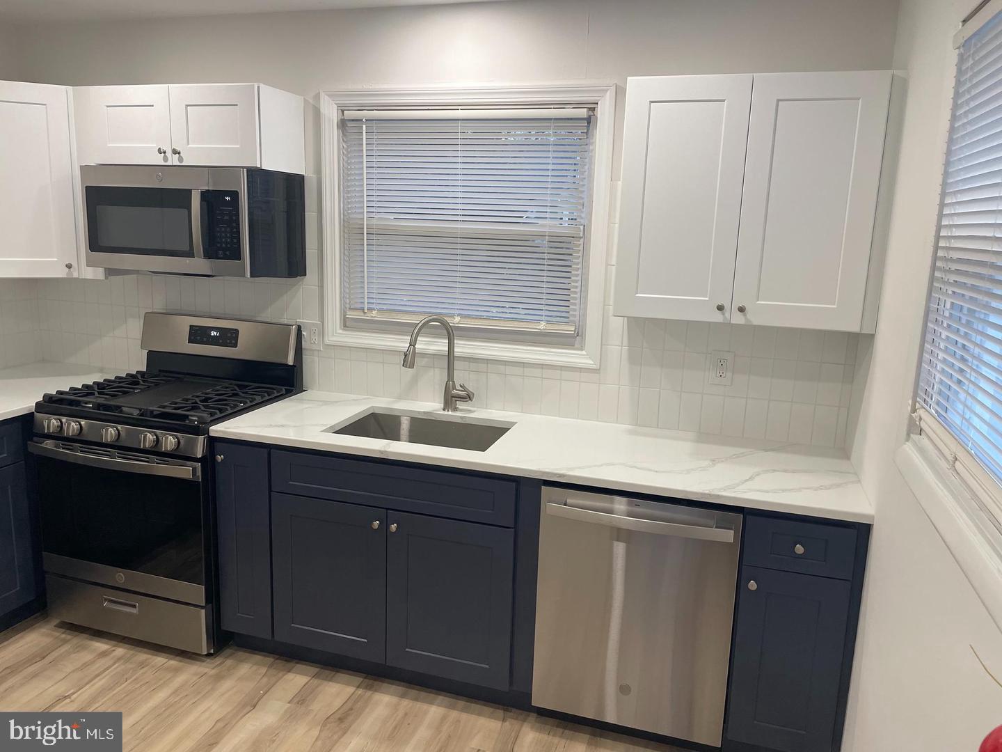 105 Breslin Avenue Haddonfield, NJ 08033 - Photo 4 of 15 a kitchen with stainless steel appliances a sink dishwasher stove and microwave