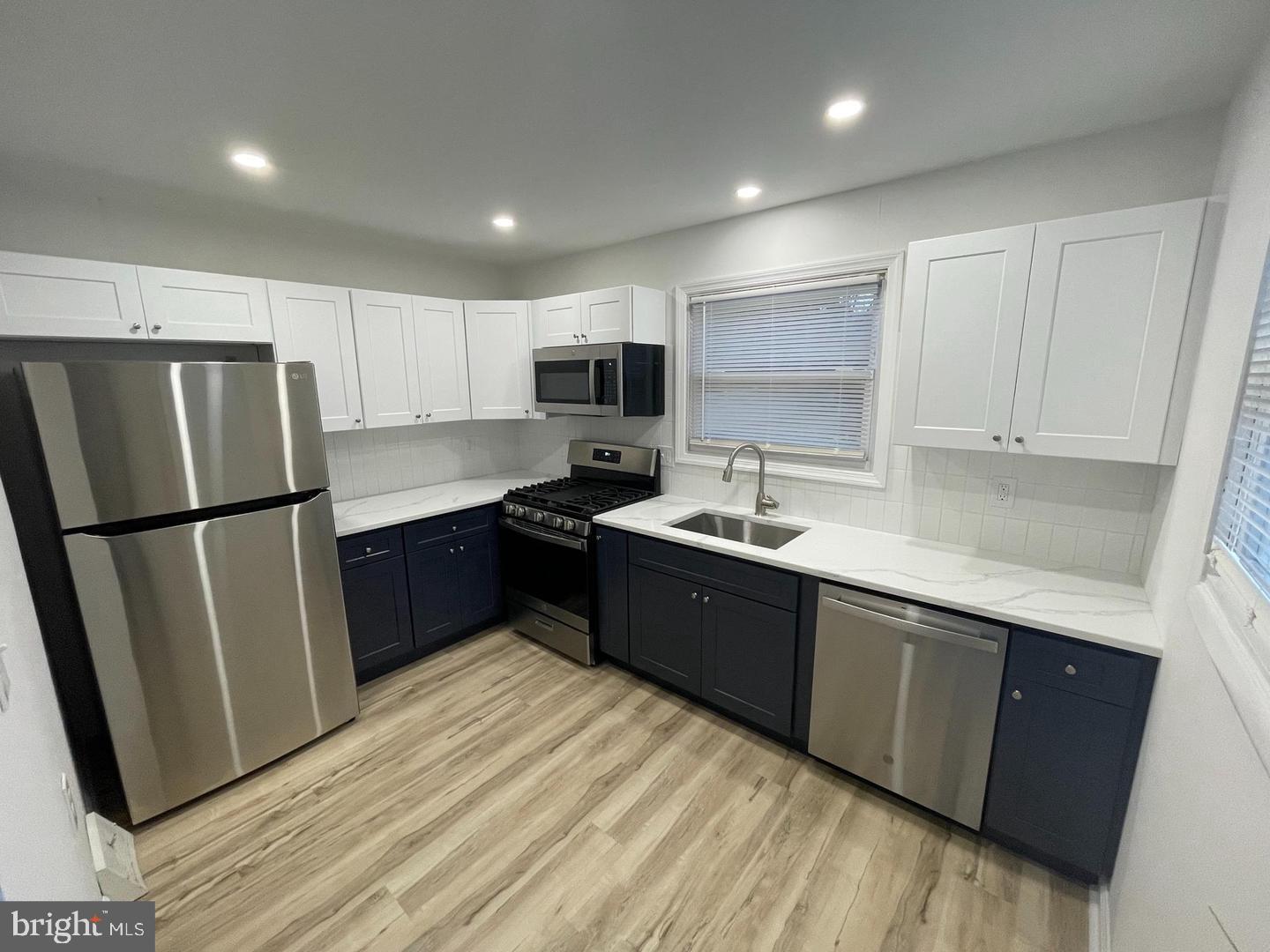 105 Breslin Avenue Haddonfield, NJ 08033 - Photo 5 of 15 a kitchen with stainless steel appliances granite countertop a refrigerator sink and cabinets