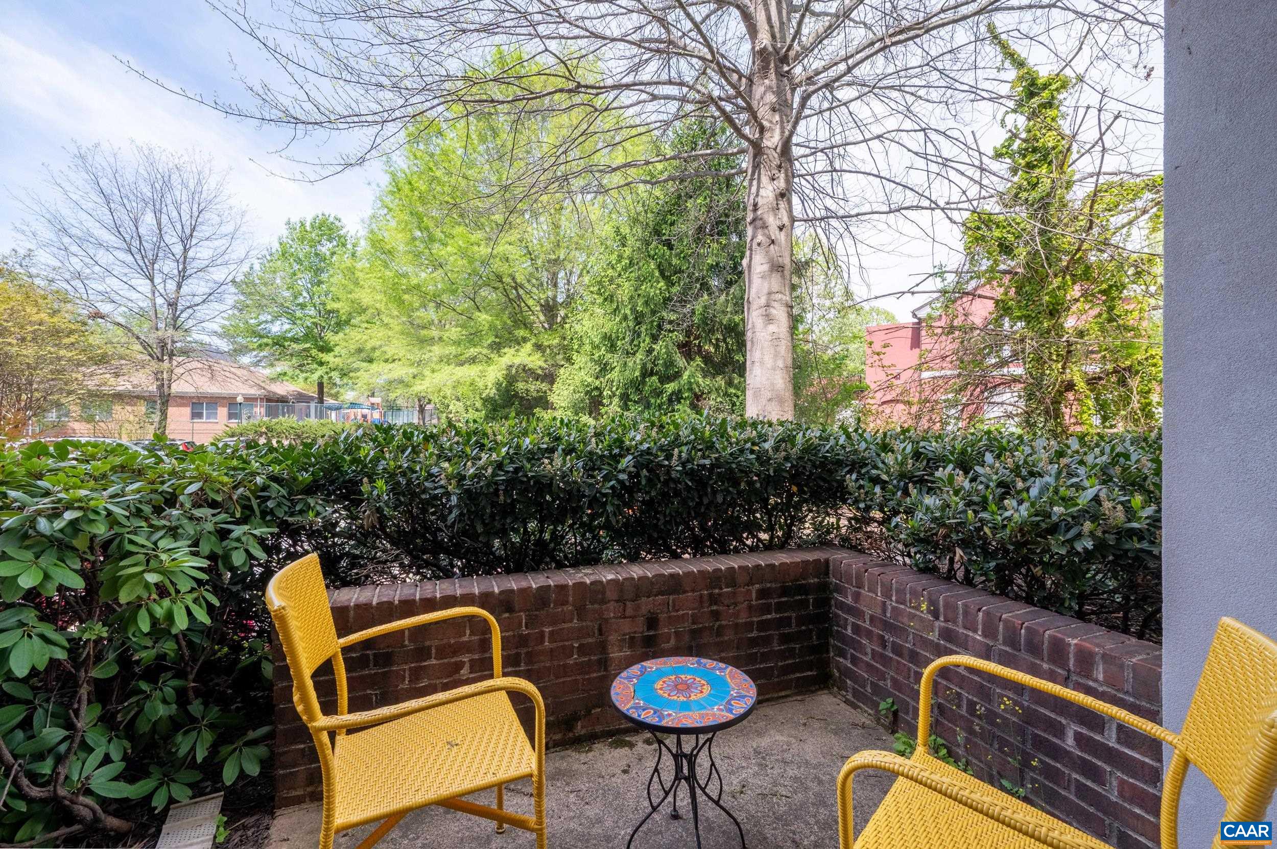765 Walker Square, Unit 2D Charlottesville, VA 22903 - Photo 14 of 33 a view of a chair and table in the backyard