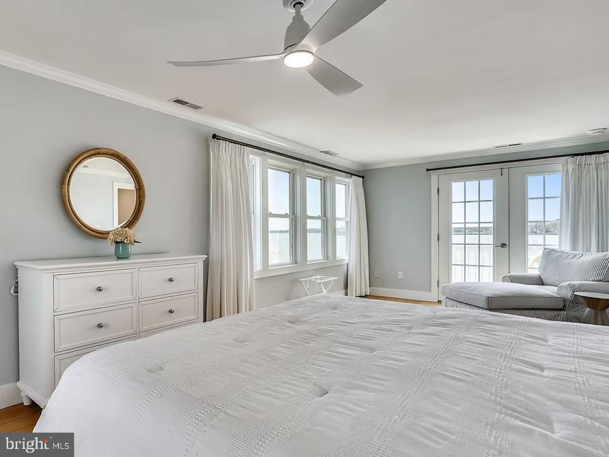 21642 Chicken Point Road Tilghman, MD 21671 - Photo 33 of 63 a bedroom with a large bed and a large window