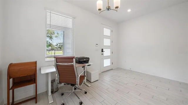 a view of a livingroom with wooden floor and a window