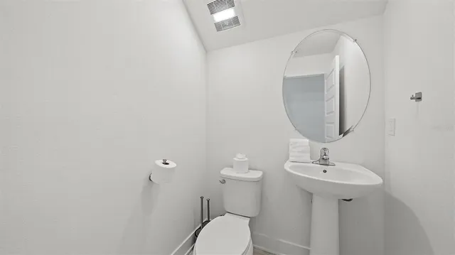 a spacious bathroom with a shower a sink and a mirror