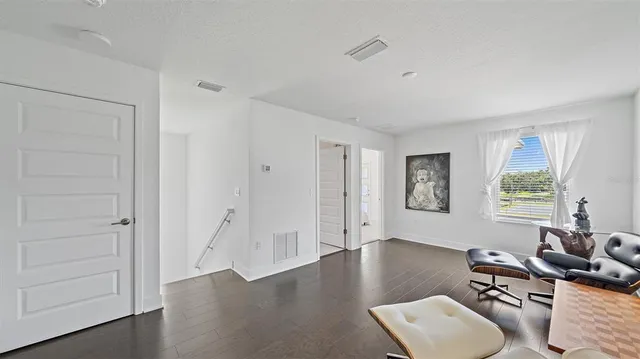 a bedroom with a bed and a chair