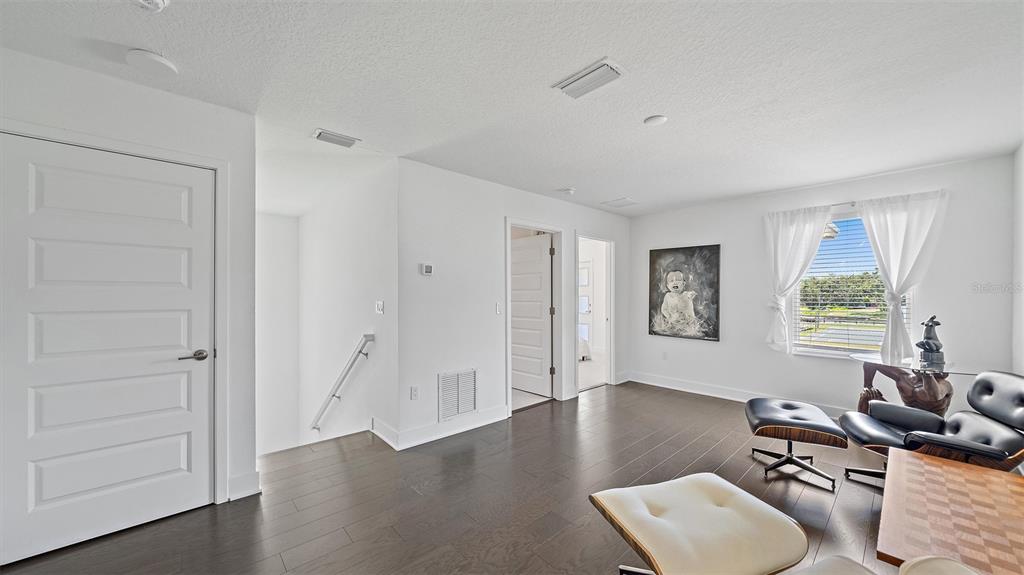 2587 Temple Street Sarasota, FL 34239 - Photo 20 of 54 a workspace with wooden floor and a window