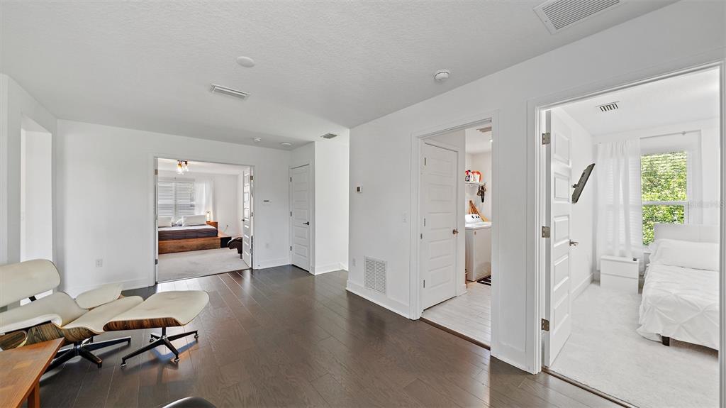 2587 Temple Street Sarasota, FL 34239 - Photo 22 of 54 a view of a livingroom with wooden floor and a window