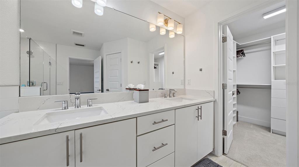 2587 Temple Street Sarasota, FL 34239 - Photo 29 of 54 a bathroom with a sink double vanity and a mirror