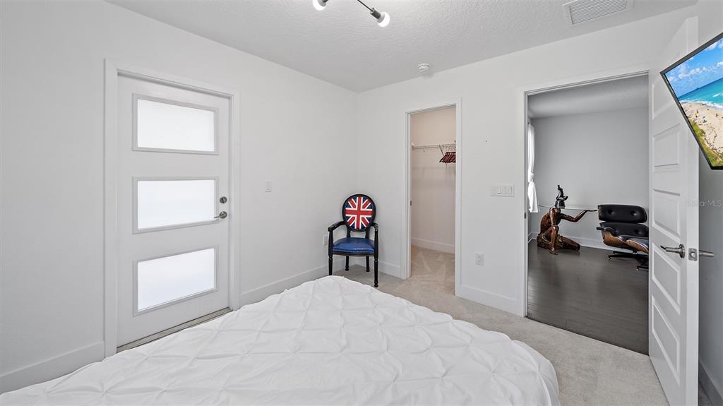2587 Temple Street Sarasota, FL 34239 - Photo 33 of 54 a bedroom with a bed and a closet