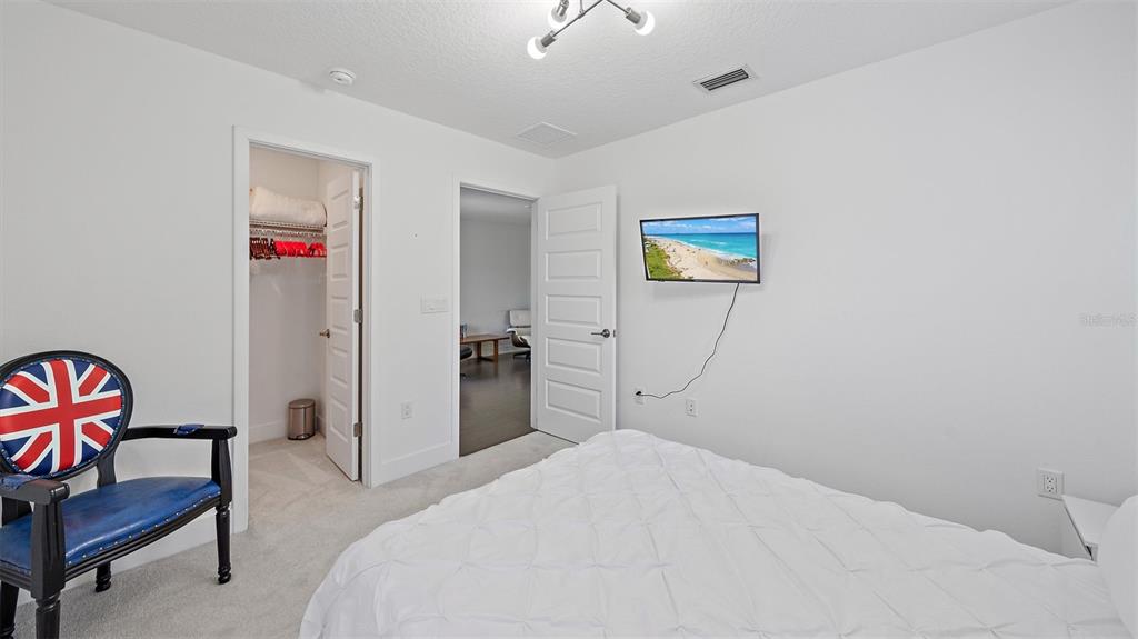 2587 Temple Street Sarasota, FL 34239 - Photo 34 of 54 a bedroom with a bed and a chair