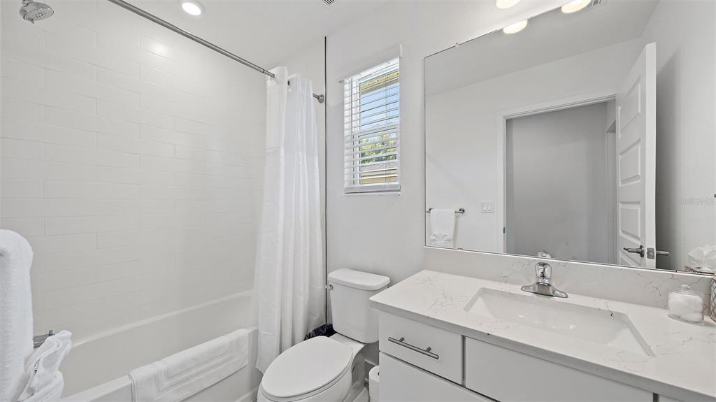 2587 Temple Street Sarasota, FL 34239 - Photo 37 of 54 a bathroom with a sink a toilet and shower