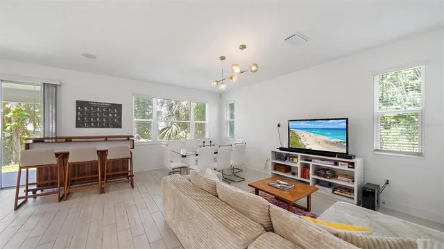 a living room with furniture and kitchen view