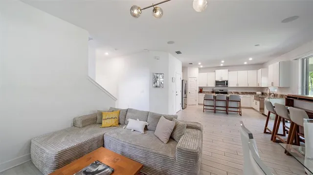 a kitchen with a refrigerator a stove and a sink