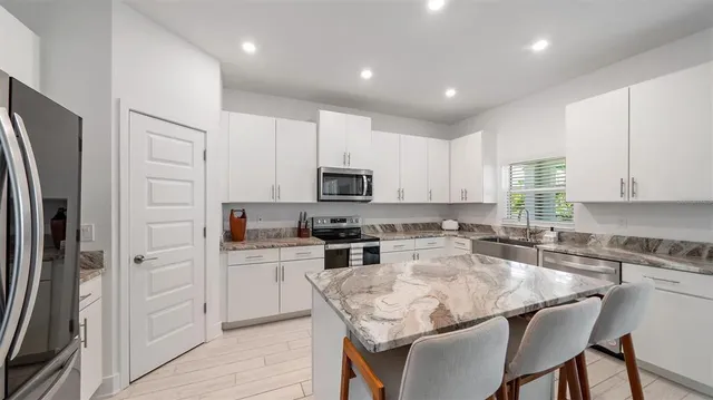 a kitchen with a sink stove top oven and microwave