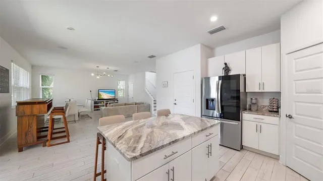 a kitchen with stainless steel appliances granite countertop a sink a stove and a microwave