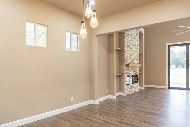 a view of a livingroom with a ceiling fan and window