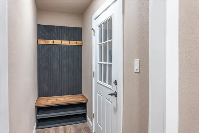 a bathroom with a granite countertop sink a light fixture and a mirror