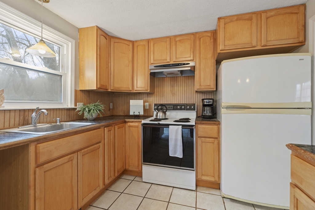 283 Orchard Street Millis, MA 02054 - Photo 14 of 41 a kitchen with stainless steel appliances granite countertop a refrigerator sink and cabinets