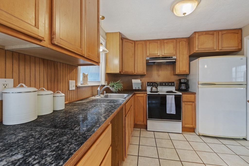 283 Orchard Street Millis, MA 02054 - Photo 15 of 41 a kitchen with stainless steel appliances granite countertop a refrigerator a stove a sink and a white cabinets