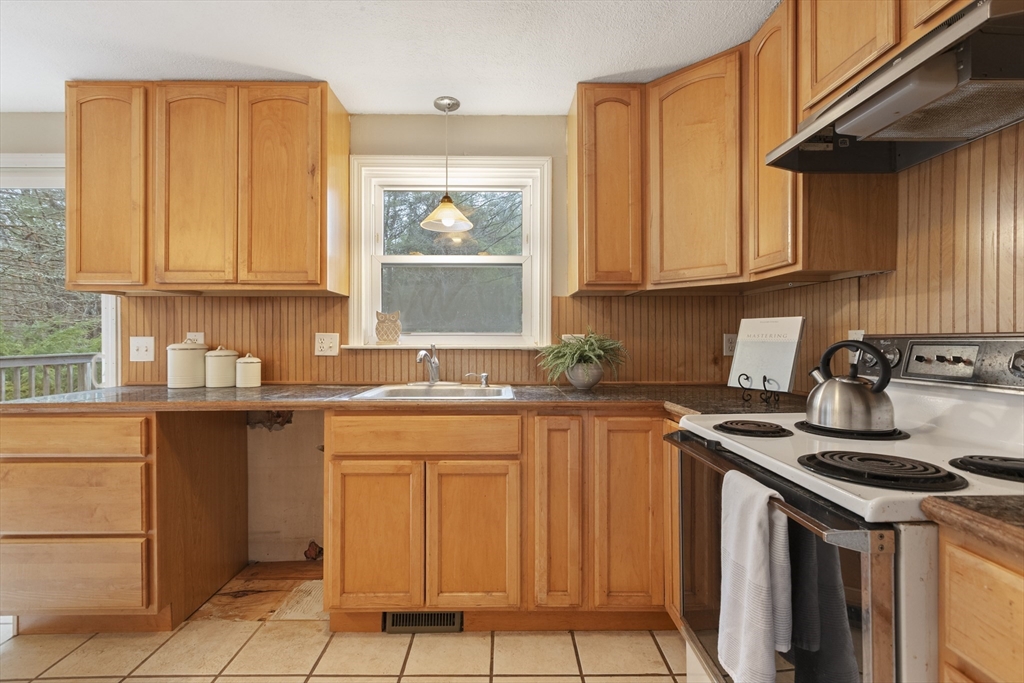 283 Orchard Street Millis, MA 02054 - Photo 16 of 41 a kitchen with stainless steel appliances granite countertop a sink stove and cabinets
