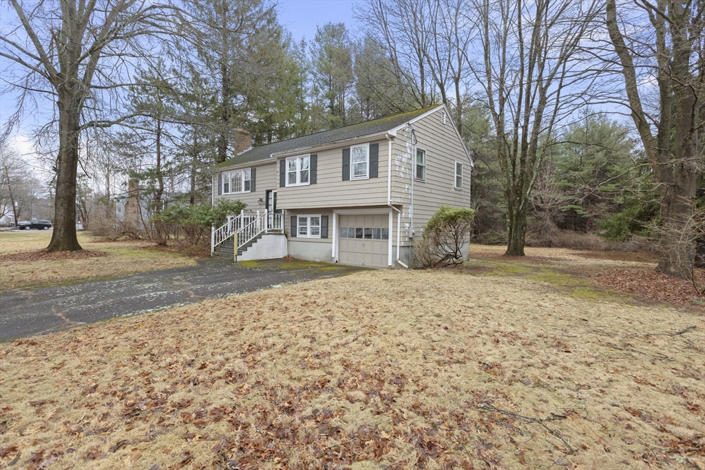 283 Orchard Street Millis, MA 02054 - Photo 39 of 41 a backyard of a house with oven and yard