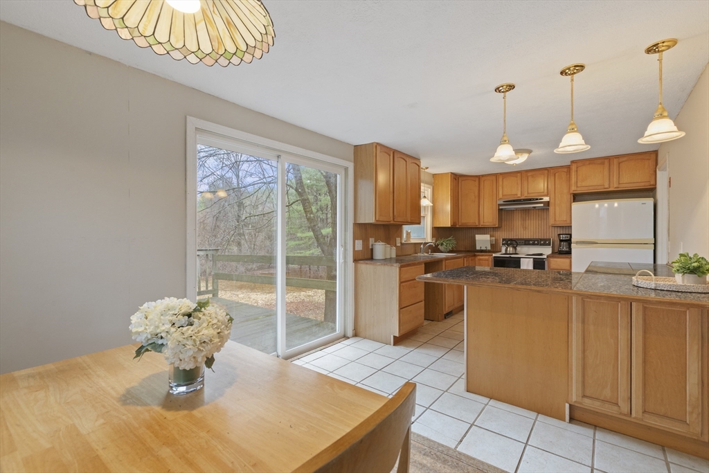 283 Orchard Street Millis, MA 02054 - Photo 8 of 41 a kitchen with stainless steel appliances granite countertop a sink a stove and a refrigerator