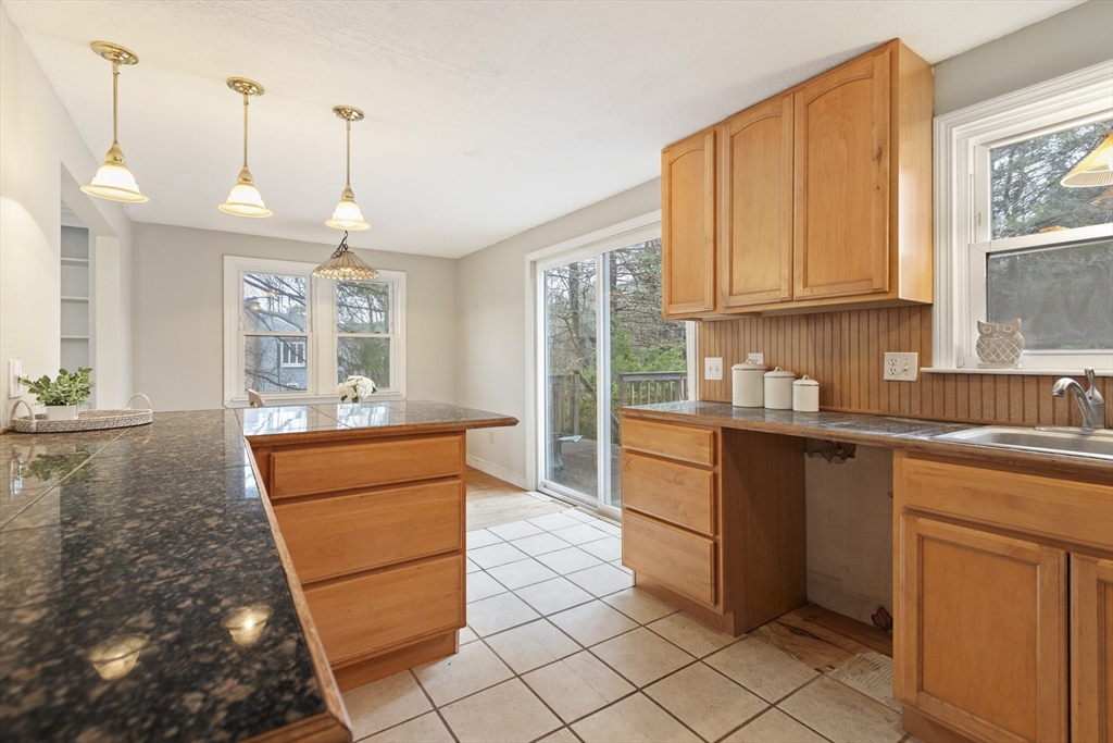 283 Orchard Street Millis, MA 02054 - Photo 10 of 41 a kitchen with stainless steel appliances granite countertop a refrigerator a sink a stove with white cabinets