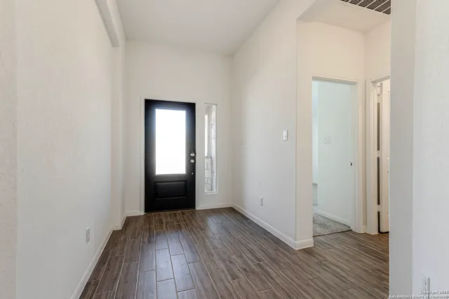 a view of a hallway with wooden floor