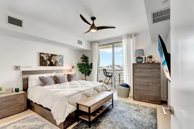 a bedroom with a bed and a flat screen tv