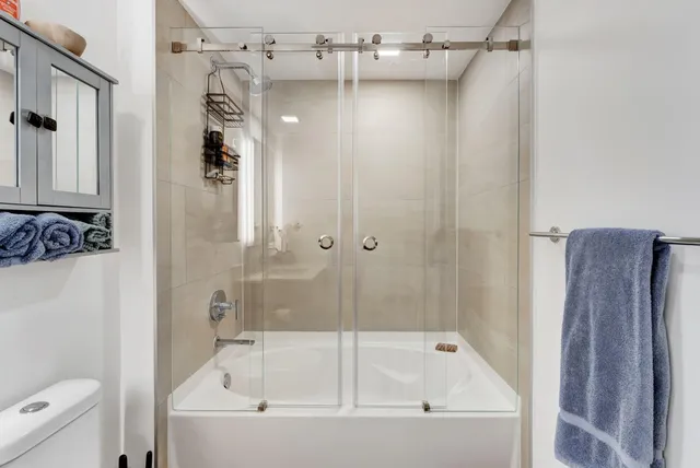 a bathroom with a bathtub and a shower