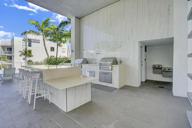 a view of a chair and table in backyard of the house